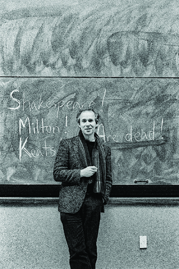 photo of the poet Bill Manhire in the early 1990s standing at a&nbsp;blackboard